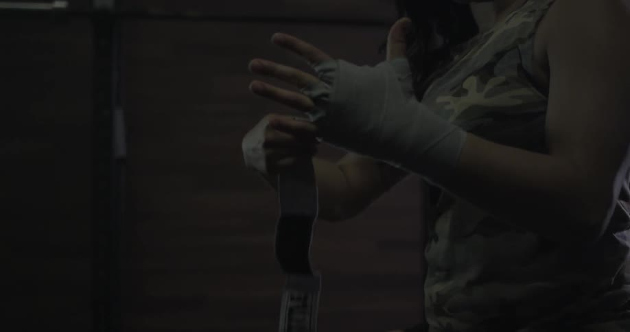 Woman wrapping her hands in preparation of a workout