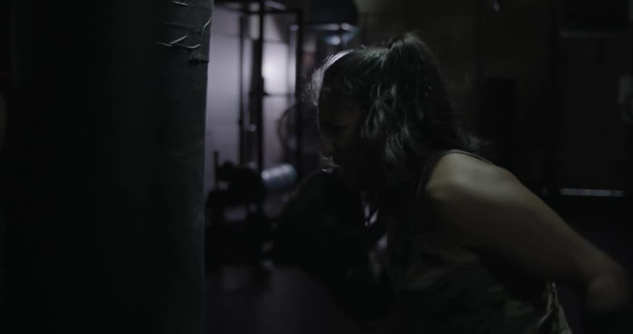 A woman punches a punching bag