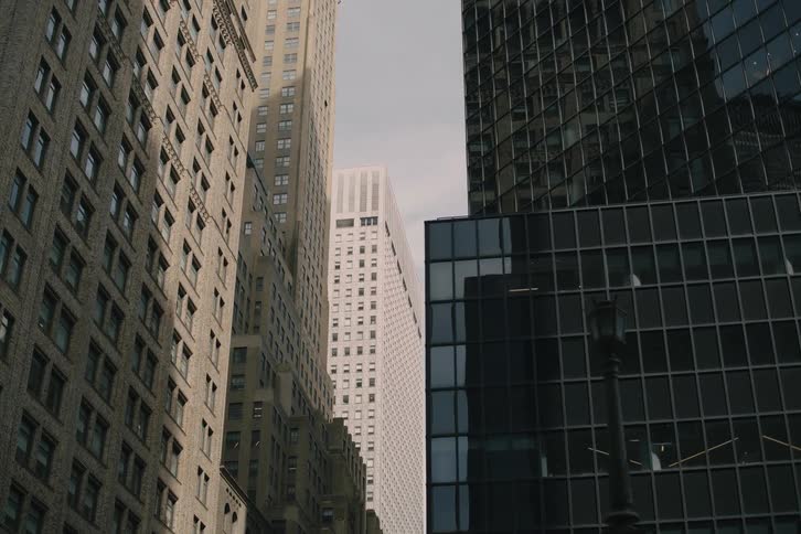 A low-angle slow dolly shot reveals Park Avenue and East 41st Street signs amidst towering New York City skyscrapers