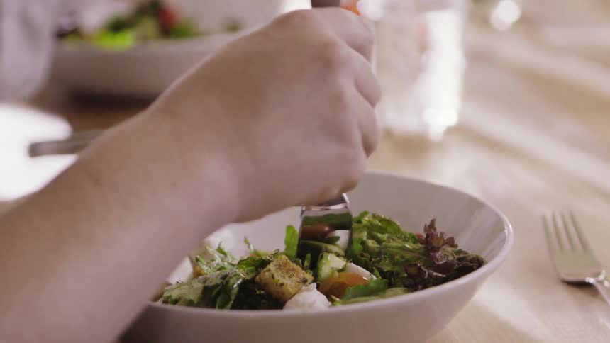 People eating salads from their bowls