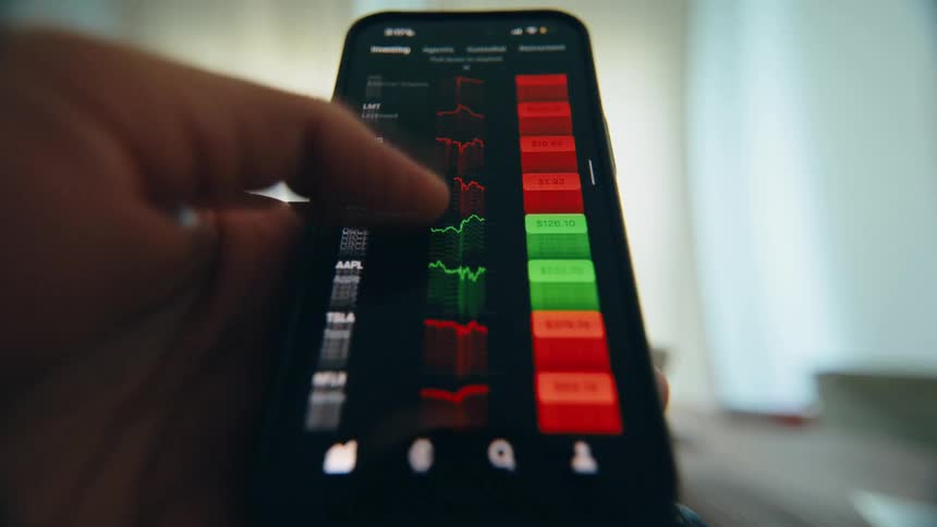 An investor analyzes stock market trends and financial data on a smartphone, rapidly scrolling through an investment app with a glitchy visual effect