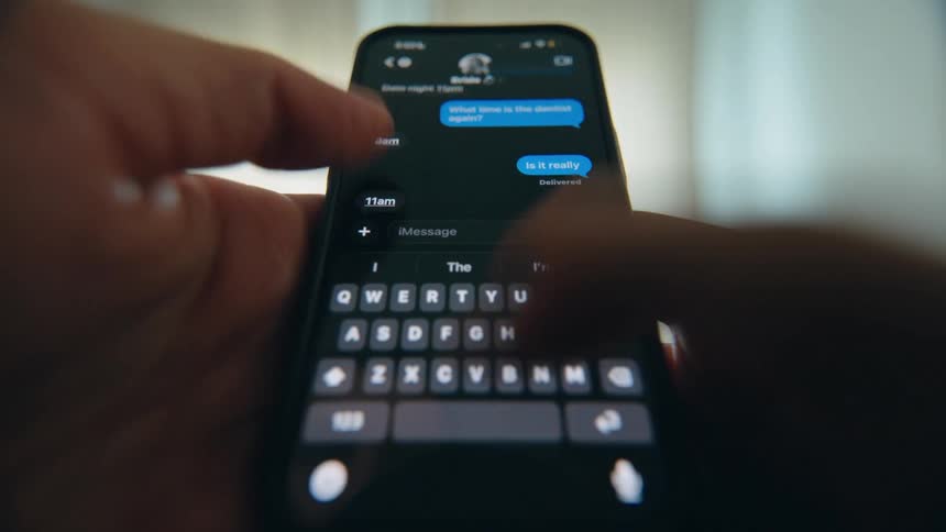 A close-up, point-of-view shot of a person's hands holding a smartphone and sending text messages back and forth
