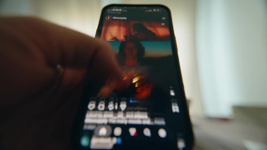 A close-up, point-of-view shot of a person rapidly scrolling through a social media feed on their smartphone