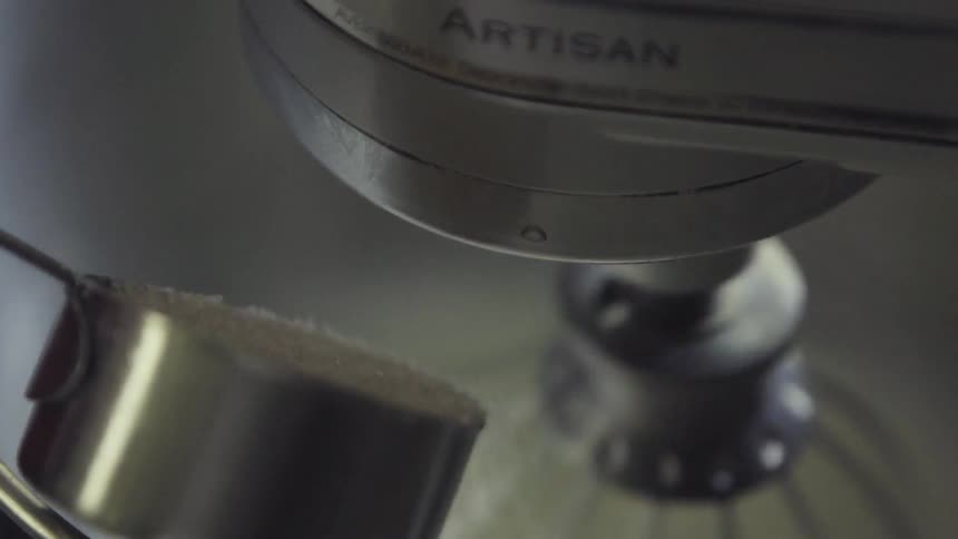 Sugar is being poured into a mixer