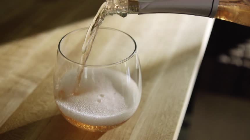 Wine is poured into a wineglass