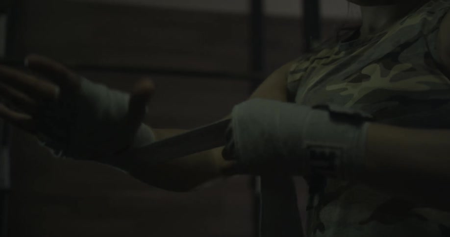 Woman wrapping her hands in preparation of a workout