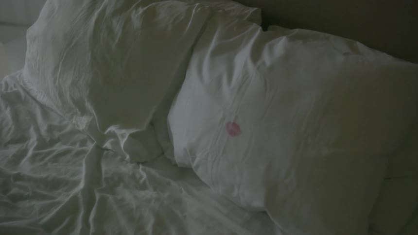 A kiss mark is shown on a white pillowcase