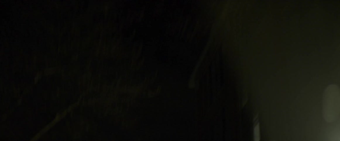 The sky is very dark with smoke and light flashing