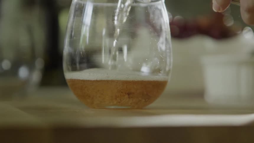 Champagne is poured into a wine glass