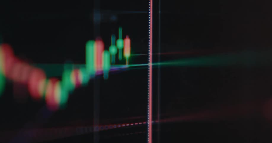 A cinematic, out-of-focus macro shot of a real-time stock market candlestick chart on a digital screen