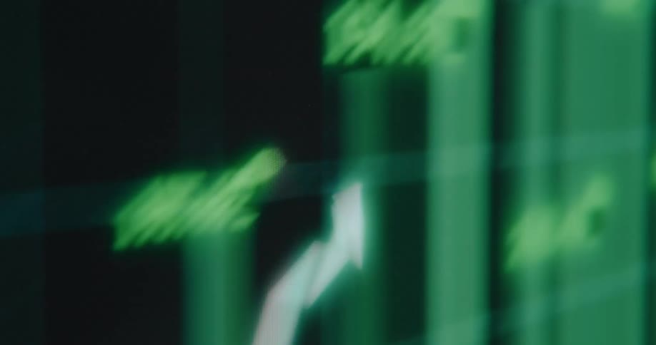 An abstract and distorted close-up of a rising green stock market chart on a digital screen