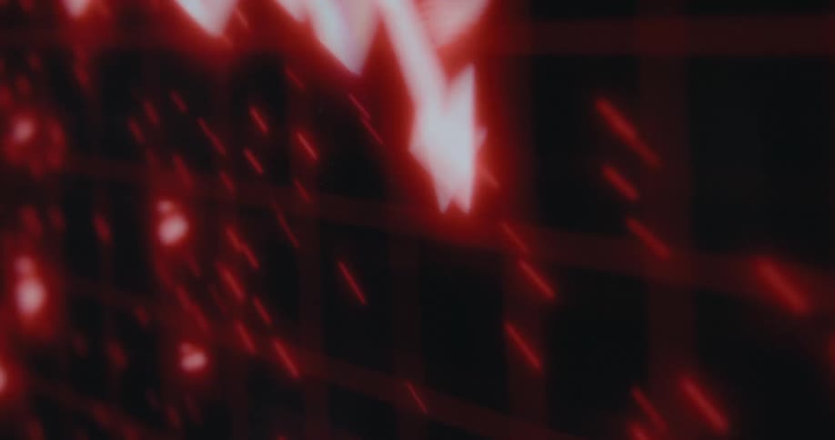 A glowing red digital graph on a screen shows a sharp downward trend, symbolizing a financial market crash