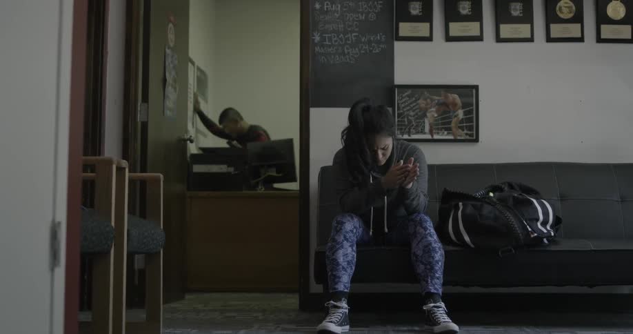 Woman sits on a couch in a waiting room
