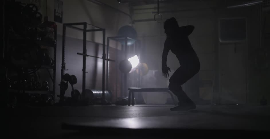 A woman dances in a weight room