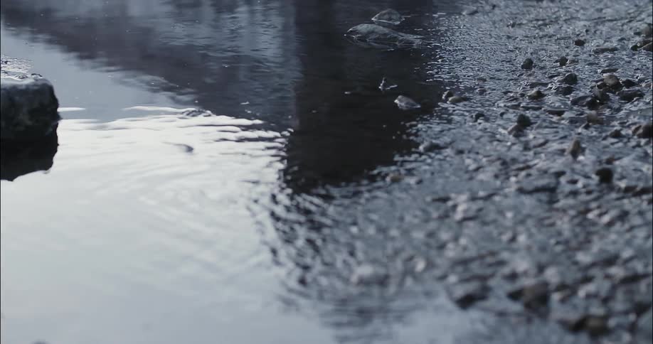 Reflection of a person in a shallow flowing stream