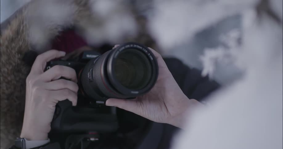 Person takes pictures outside on a snowy day