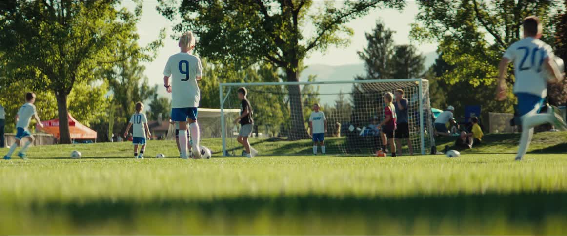 Low angle shot of a youth soccer team practicing their skills on a sunny field