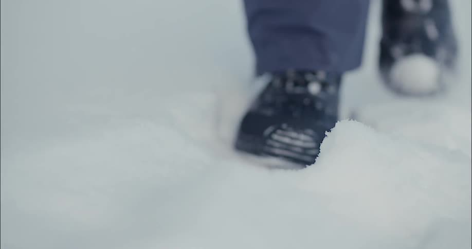 A person is walking in the snow