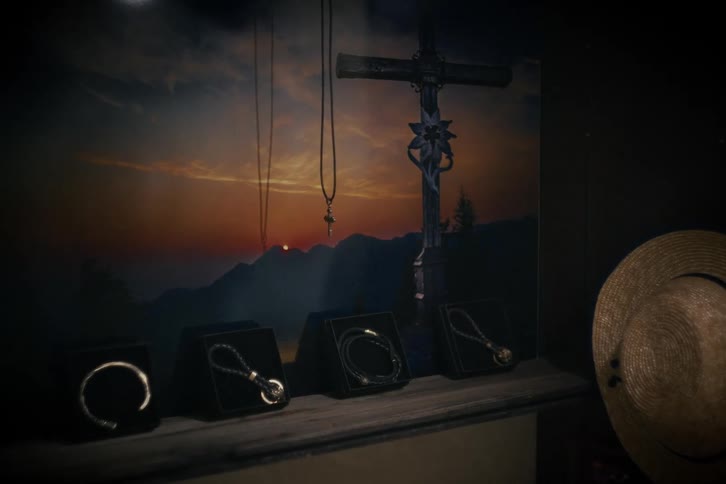 A mysterious and dimly lit display of religious-themed jewelry, including bracelets and necklaces, set against a backdrop of a mountain sunset and a crucifix