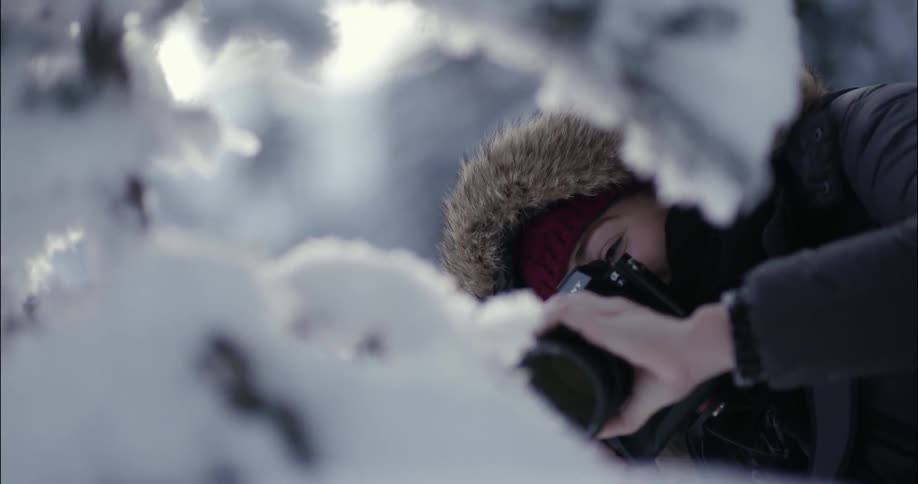 Woman taking photographs on a winter day
