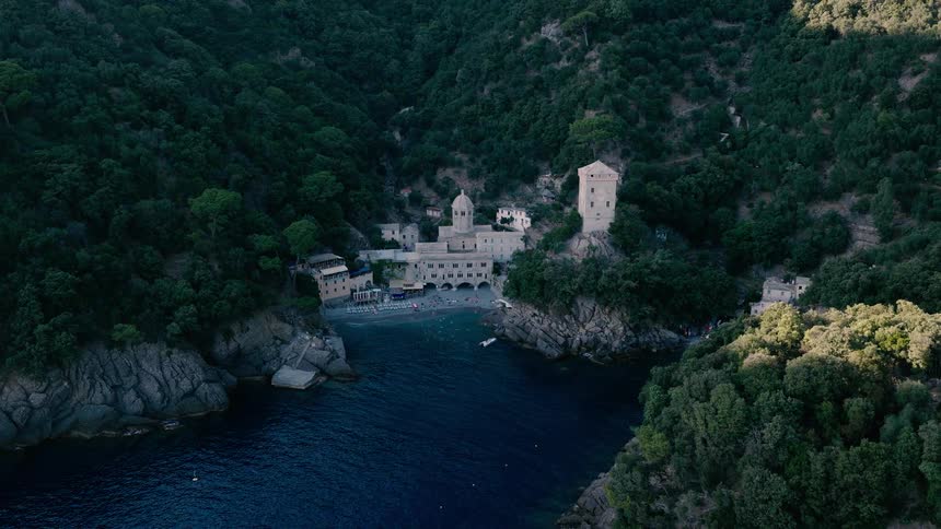 Stunning aerial view of the historic San Fruttuoso Abbey tucked away in a secluded cove on the rugged, forested Italian Riviera