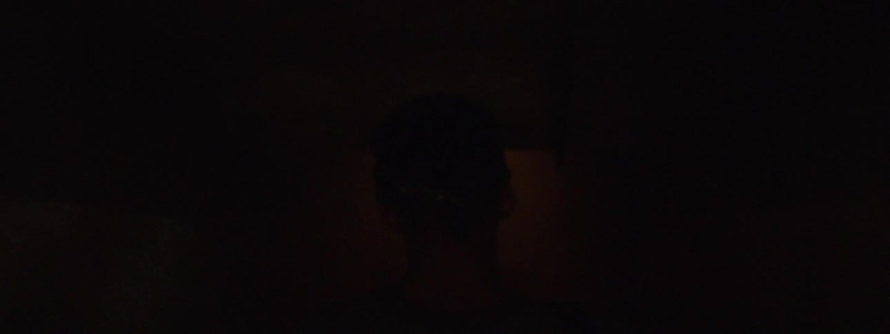 A man walks down stairs into a smoky basement