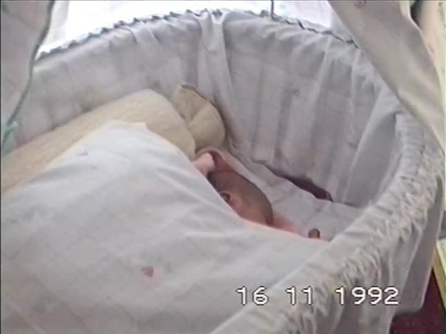 Vintage VHS home video from 1992 shows a newborn baby sleeping peacefully in a bassinet