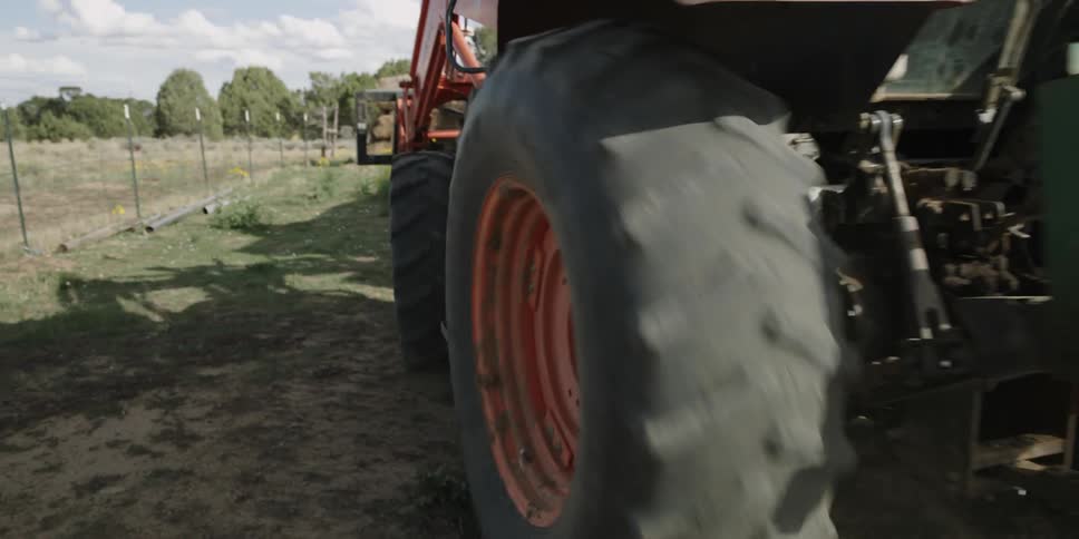 A tractor drives on a dirt road