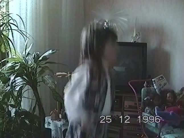 Vintage 1996 home video footage of a little girl excitedly dancing in her living room on Christmas Day