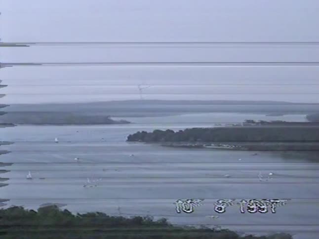 A vintage high-angle view from 1997 of sailboats on a vast lake in Berlin on a hazy day