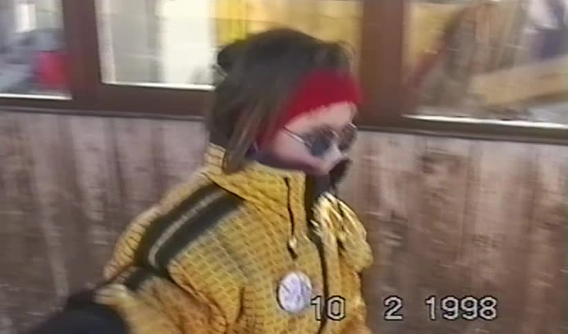 Home video from 1998 captures a young child smiling and looking cool in sunglasses on a ski trip