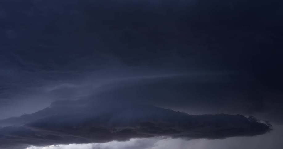 A time-lapse captures ominous dark storm clouds swirling and gathering in the sky