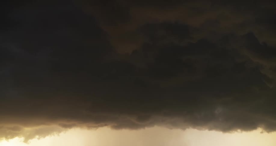 Ominous and heavy storm clouds slowly drift across the sky