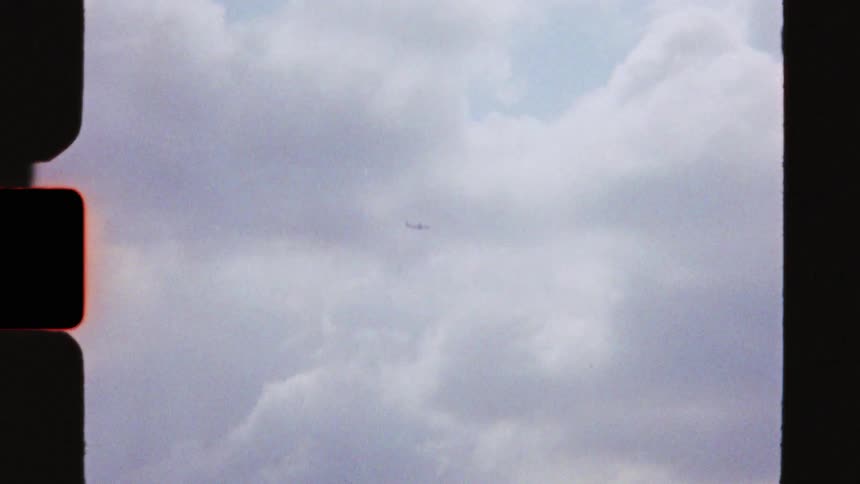 Super 8 footage of London's iconic landmarks, including the London Eye, a plane in the sky, and a boat on the River Thames with Big Ben in the background