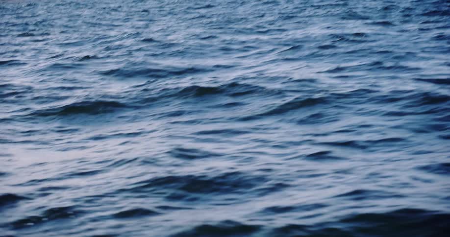 A mesmerizing close-up of the deep blue ocean surface with rolling waves and swells