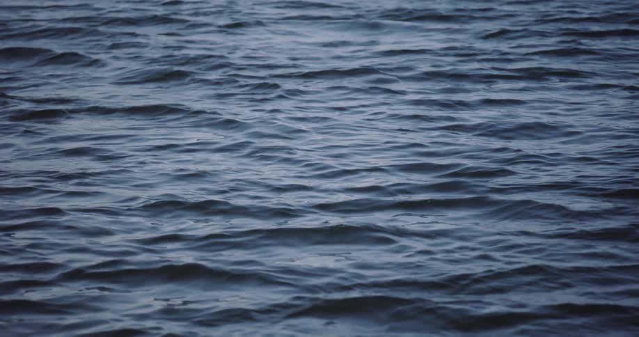 The gentle, hypnotic movement of dark blue water ripples
