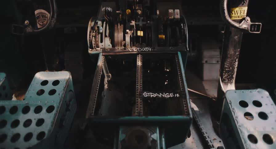 Inside the creepy, abandoned cockpit of a wrecked plane, graffiti marks the decaying control panel