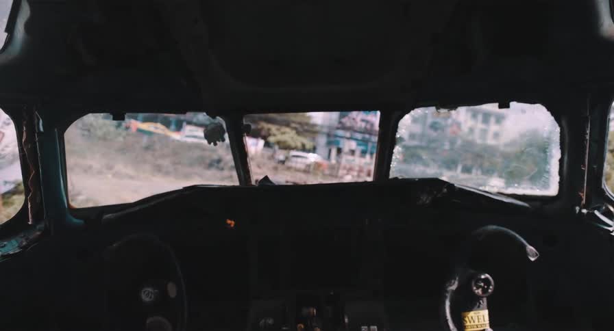 An eerie, slow zoom-out from the dark and decaying cockpit of an abandoned airplane