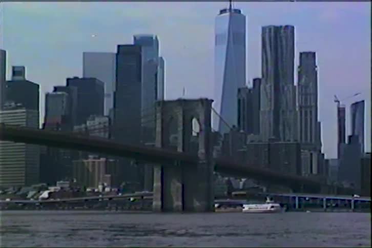 Vintage VHS footage zooms out from a close-up of the Brooklyn Bridge to reveal the iconic Manhattan skyline