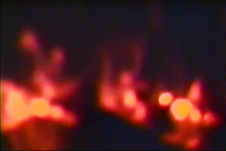 An abstract and blurry shot captures the flickering flames of a fire at night
