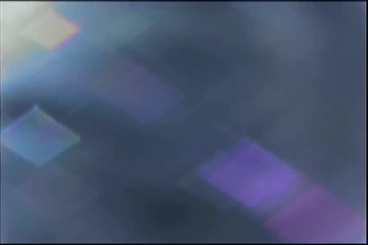 Chaotic vintage footage zooms into a flock of pigeons, creating an abstract blur of flapping wings and light