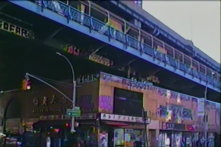 Vintage 90s camcorder footage captures a gritty, graffiti-covered street corner in Chinatown, New York City