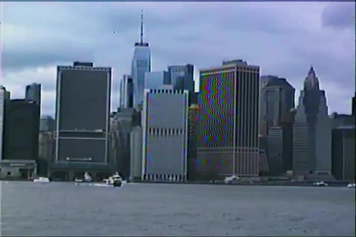 Authentic VHS footage of the New York City skyline slowly zooming in on the One World Trade Center on an overcast day