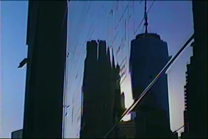 Vintage VHS footage captures a distorted reflection of the Chicago skyline, featuring the John Hancock Center, on a glass building at dusk