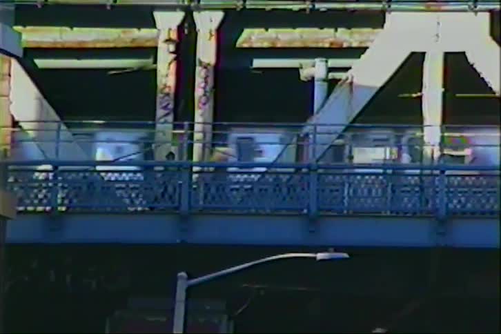 Vintage VHS footage shows a subway train traveling on an elevated track through Chinatown in a bustling city