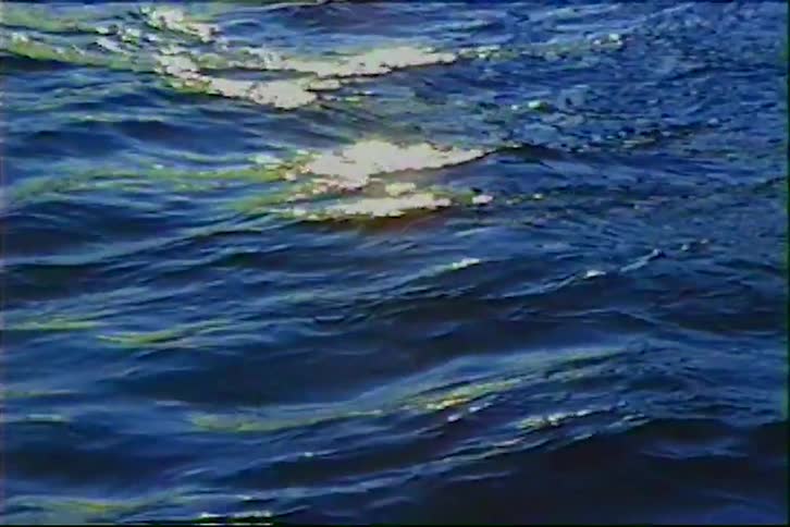 Vintage style close-up of the sun shimmering on deep blue ocean waves