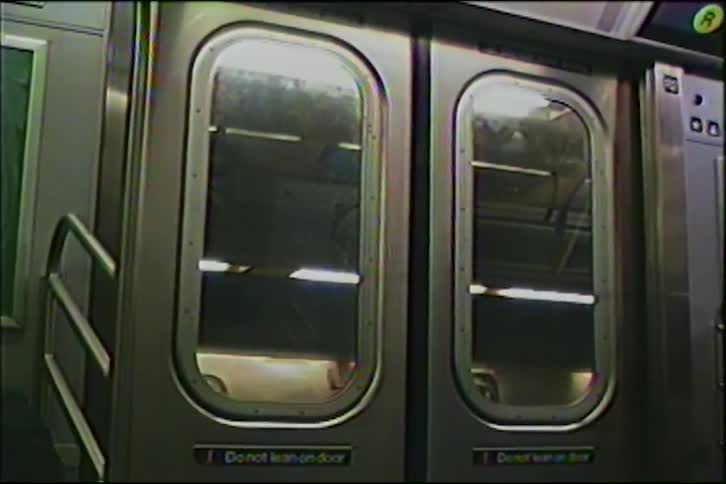 Vintage VHS footage shows the interior doors of a subway car slowly closing