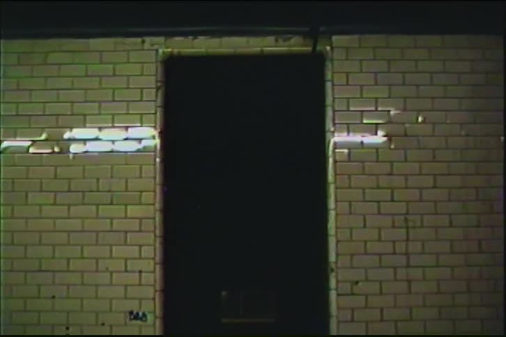Vintage VHS-style footage of a subway train speeding through a tiled underground station, creating an abstract blur of light and motion
