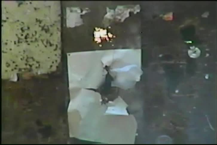 A plastic jug of water explodes in dramatic slow motion after being shot in vintage VHS footage