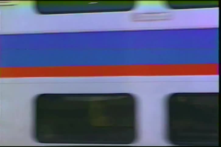Vintage VHS footage shows a MARC commuter train passing under a green bridge on a sunny day